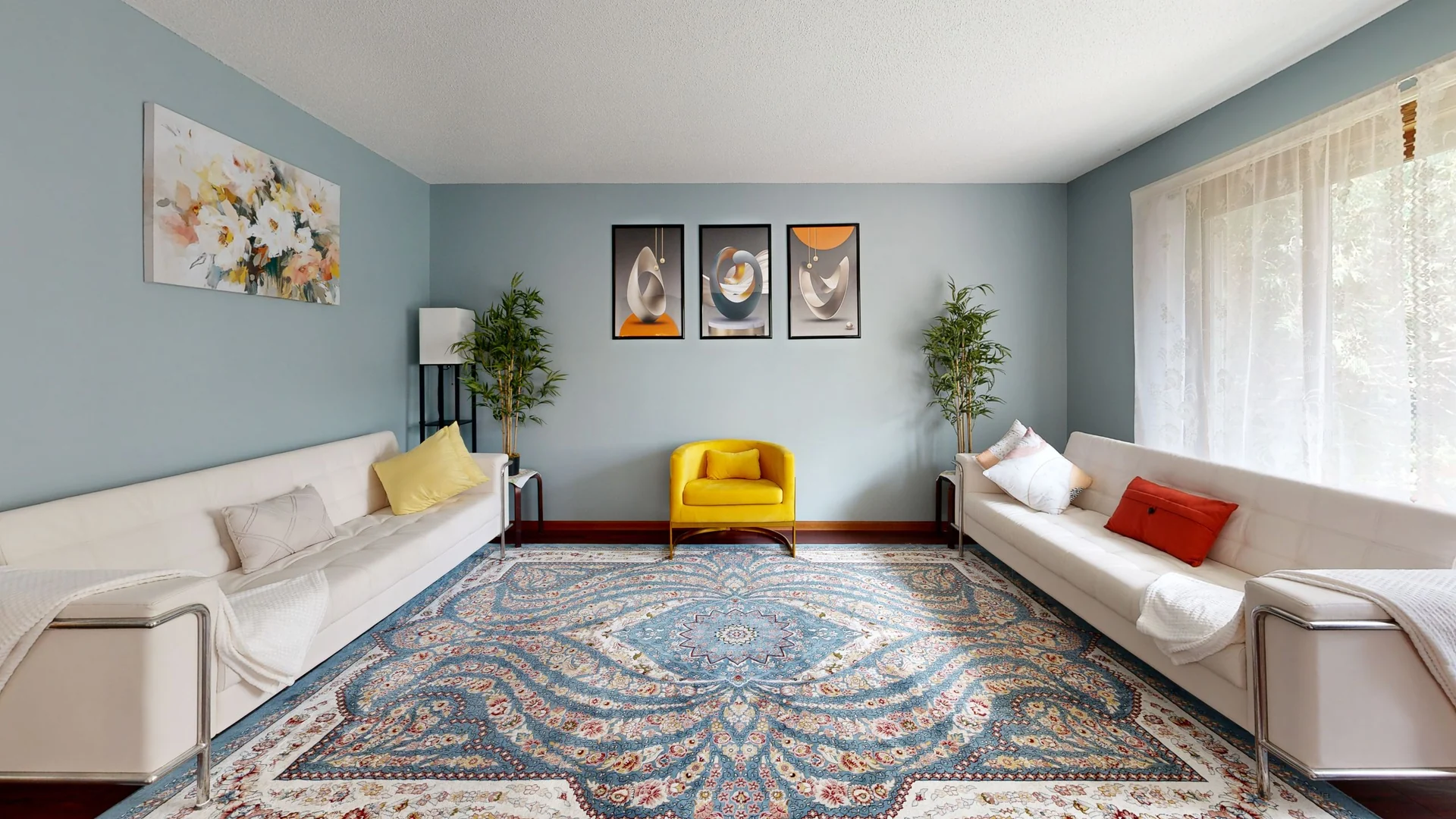 Spacious living room with minimalistic design, modern art, and vibrant colors.